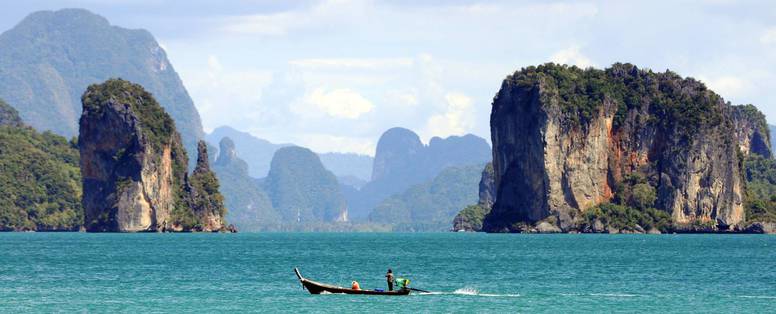 Uitzicht op de oceaan met boot bij Six Senses Yao Noi op Koh Yao Noi