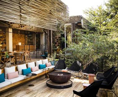 Singita-Sweni-Lodge-Lounging-area-and-bush-fire-deck-min