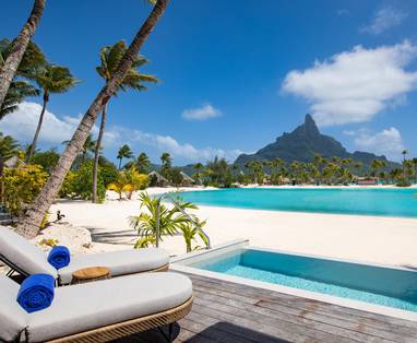 Beach villa uitzicht vanaf terras op strand met zitje en dompelbad